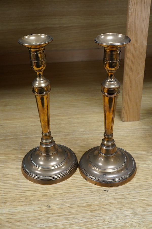 Two pairs of candlesticks to include 18th century brass ejector examples, 37cm wide. Condition - good